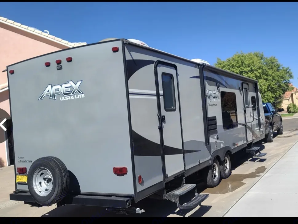 Exterior view of a gray Apex Ultra Lite travel trailer, a spacious option for RV rental adventures.. Coachmen Apex 2019