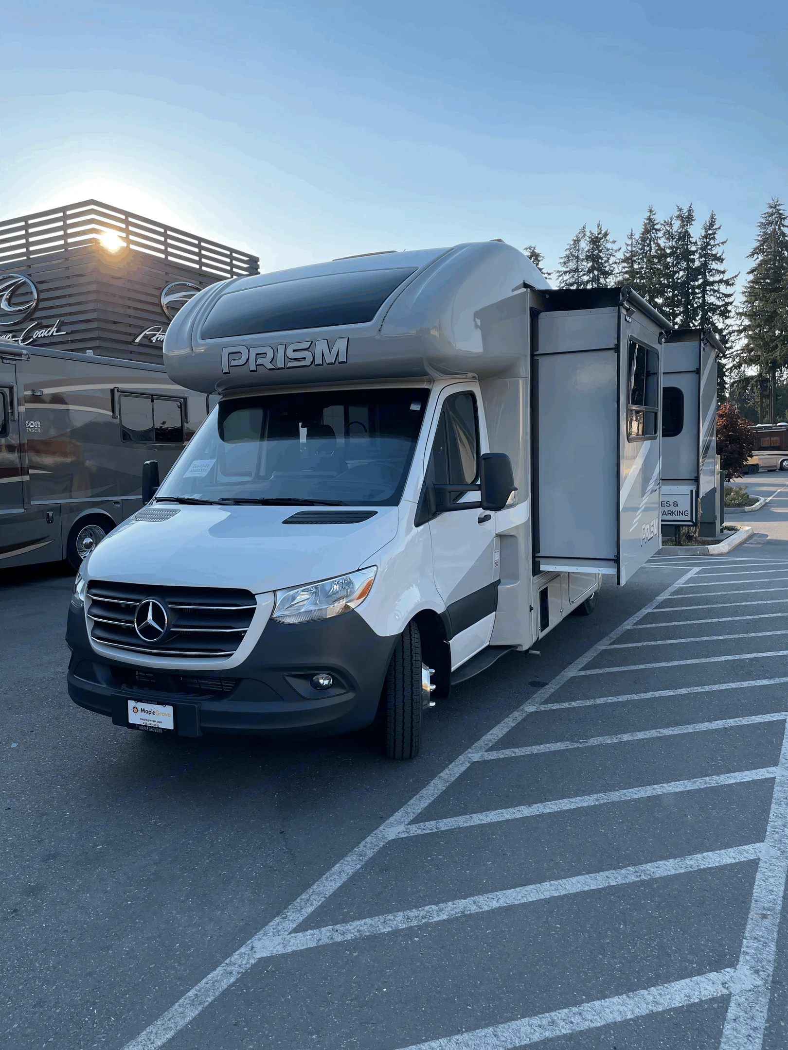 Bright day showcasing a white Mercedes Sprinter Prism RV with a slide-out extended, from Maple Grove RV, ideal for rv rental.. Coachmen Prism 2023