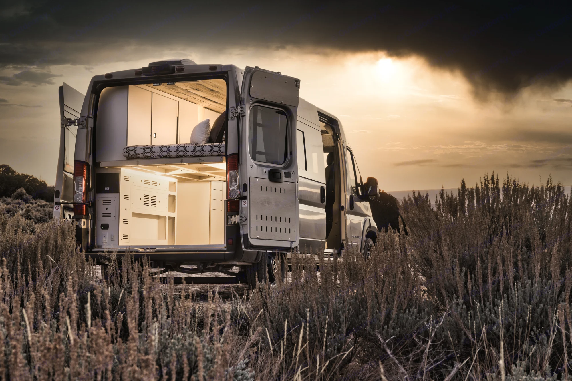 Explore with this RV rental camper van, revealing its custom interior with open doors.. DM Vans LV7 2022