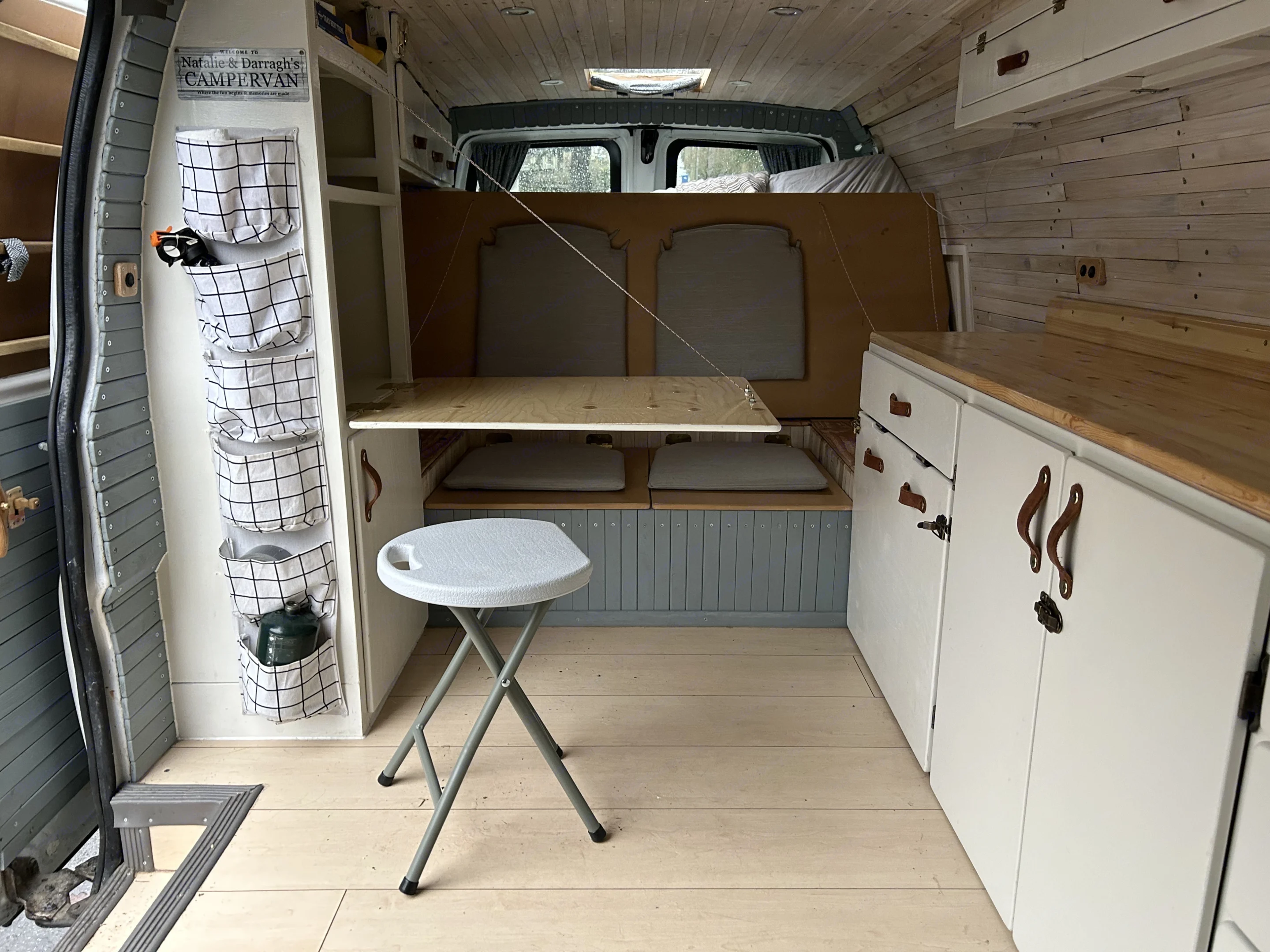 The bed folds up to reveal a seat for 2 people. The table folds down - and there is a stool if you prefer to sit face-to-face. . Chevrolet Express 2005