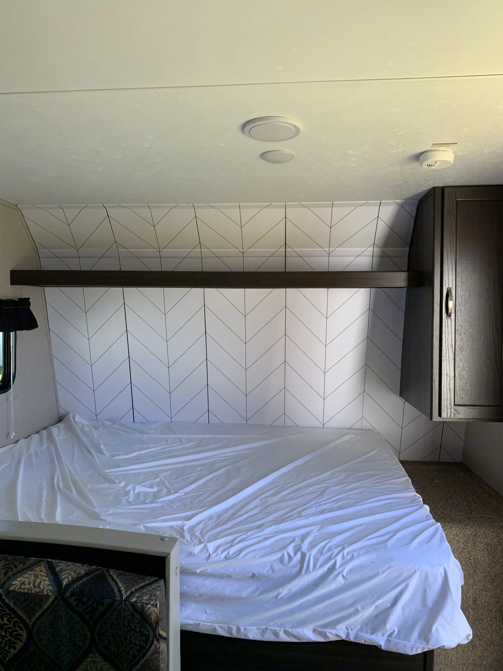 Inside an RV rental: a clean bedroom features a. Keystone Springdale 1800BH 2019