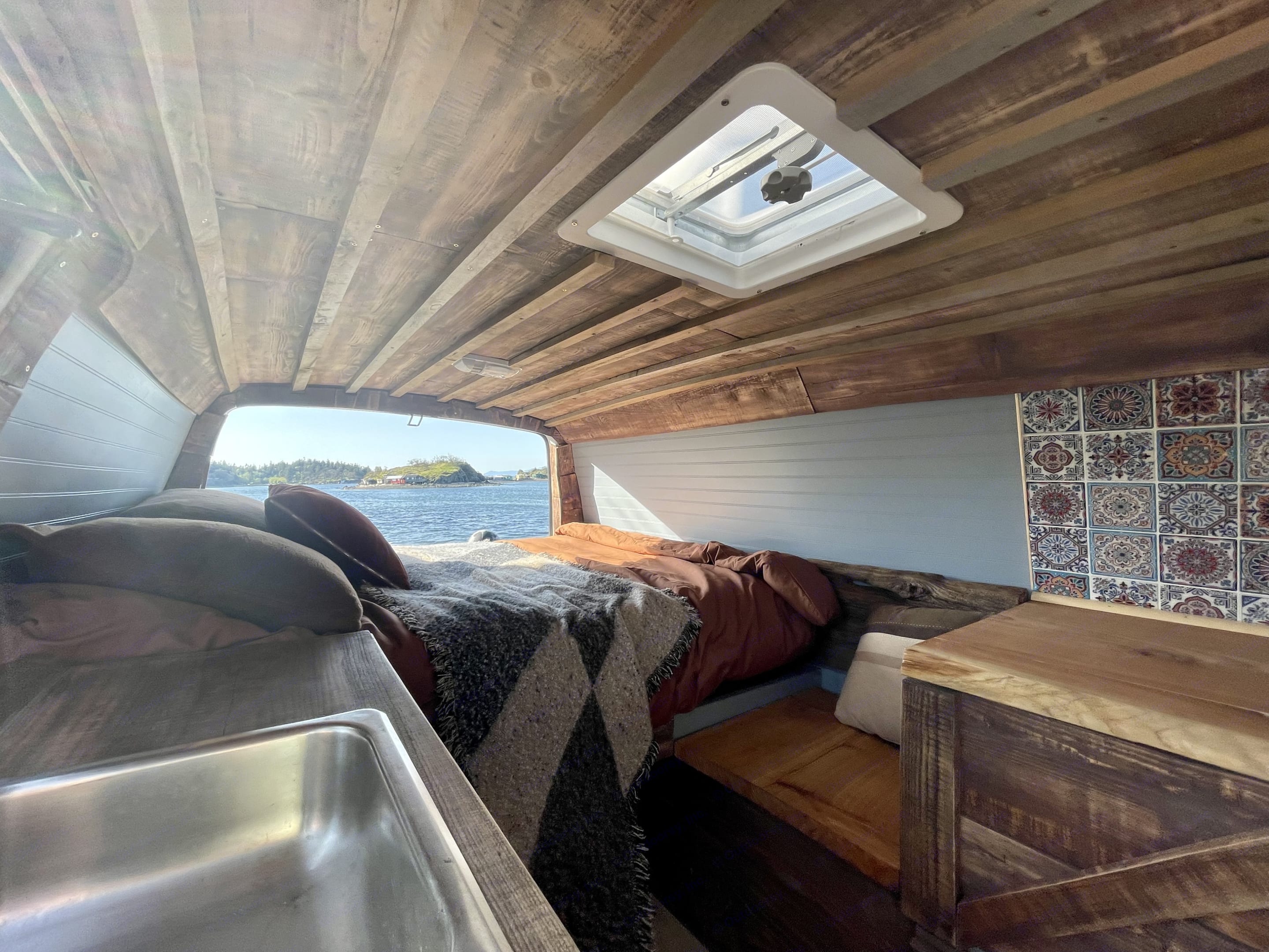 Inside sleeping area, 2 working/cooking tabletops and a sink, roof vent and live edge sitting area.. Chevrolet Other 2009
