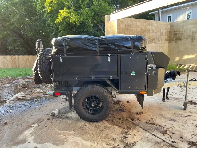 Passenger side of the trailer. It houses the inverter, water heater, and shower hose. . Patriot X1 2021
