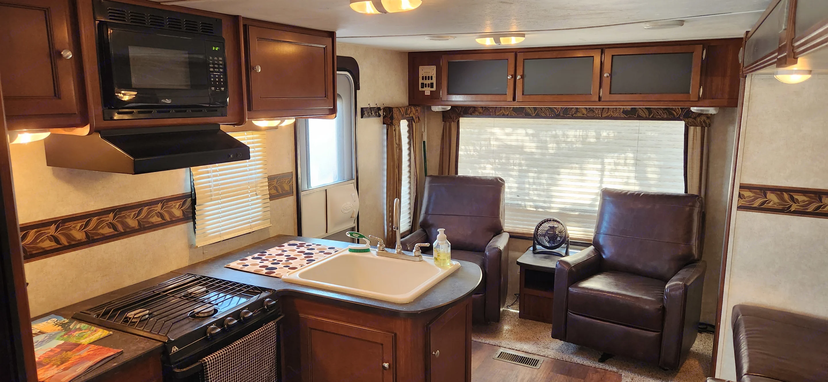 Kitchen includes microwave, LP gas stove, and oven.. Keystone RV Bullet Ultra Lite 2015