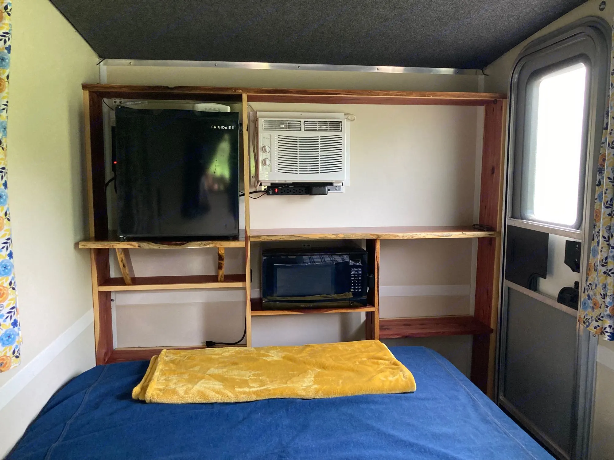 View of interior front (with mini fridge, A/C and microwave) with bed out. . Runaway Rouser 2023