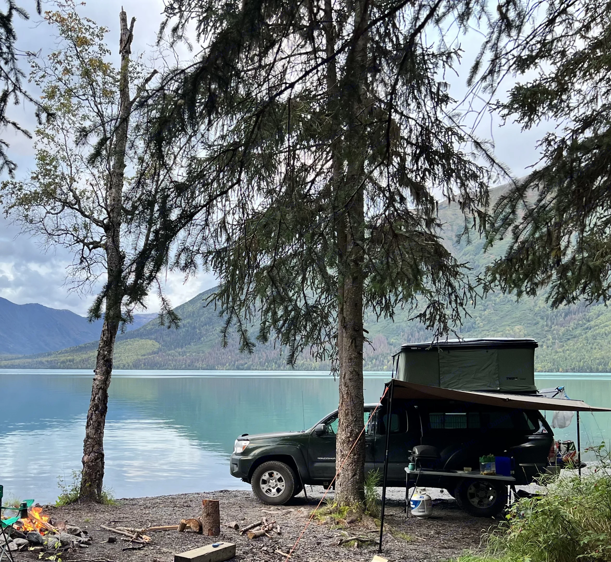 Truck with rooftop tent, campfire by. Toyota Tacoma 2012