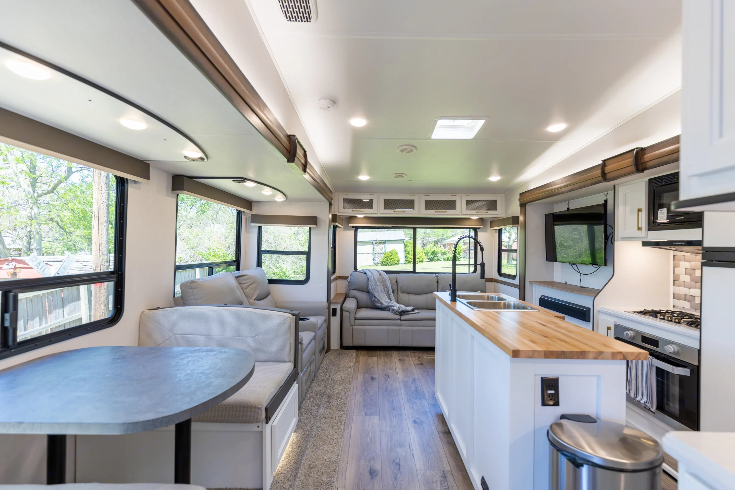Spacious living area with butcher block kitchen island and dinette. . Prime Time Crusader 330MBH 2022