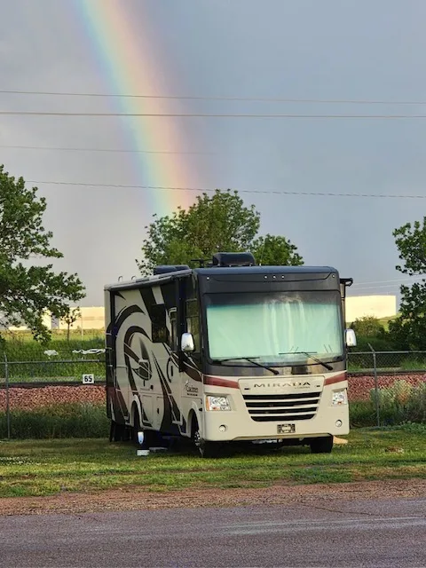 Beautiful rainbow over a parked Coachmen Mirada RV, perfect for your next rv rental adventure or camping trip.. Coachman Mirada 2018