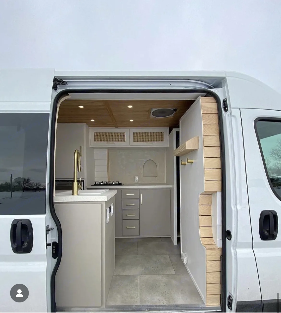 Explore this modern RV rental camper van interior, featuring a stylish kitchen & clever custom-built storage.. Ram Promaster 2020