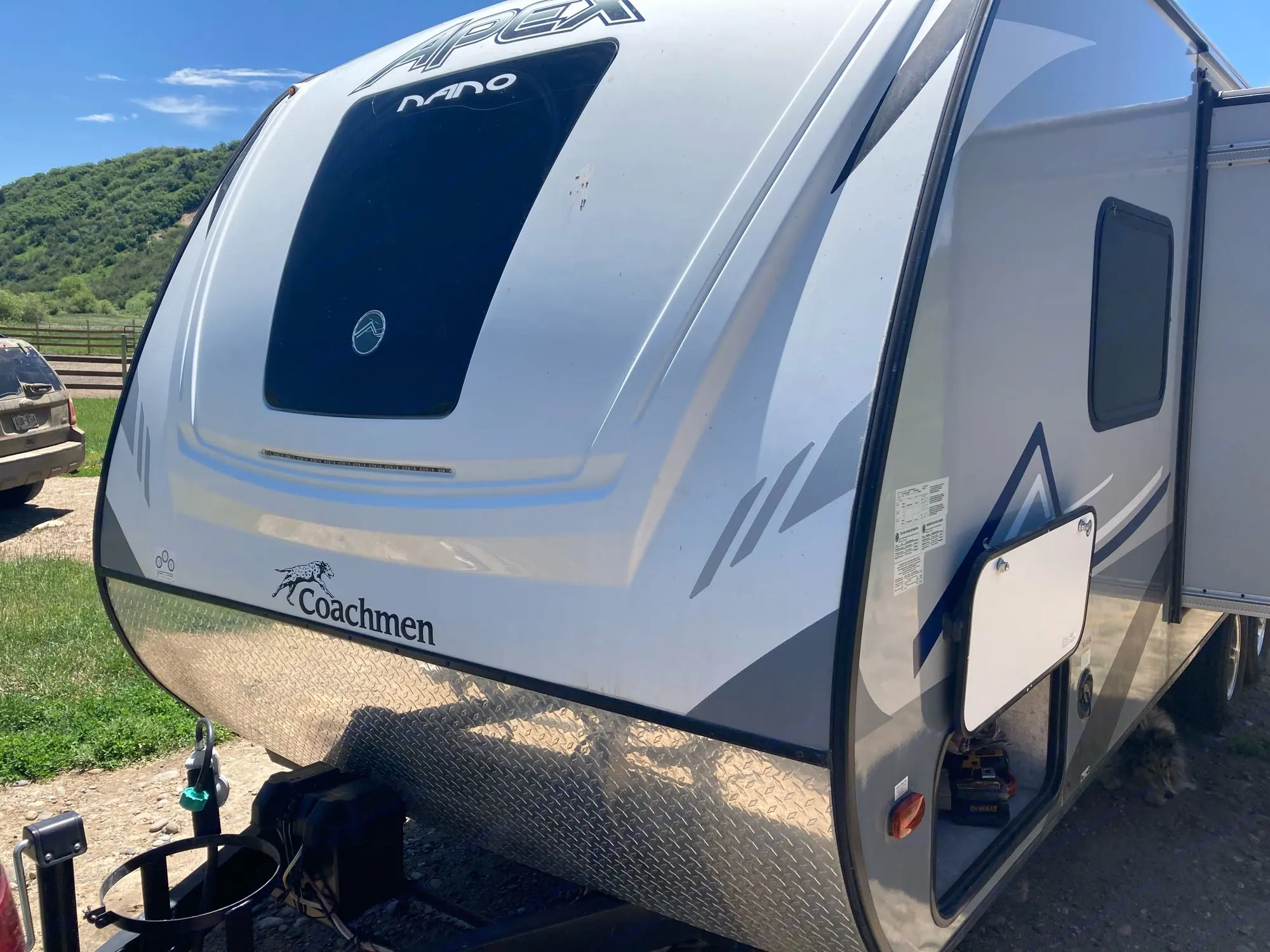 Front view of a white and gray Coachmen Apex Nano RV travel trailer, ready for an RV rental adventure.. Coachmen Apex Nano 2020