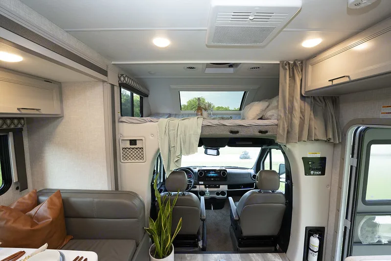 Driving area and bunk above seats. Comes with a step ladder to get up on the bunk and star gazing window which can open and close.. Thor Chateau 2023