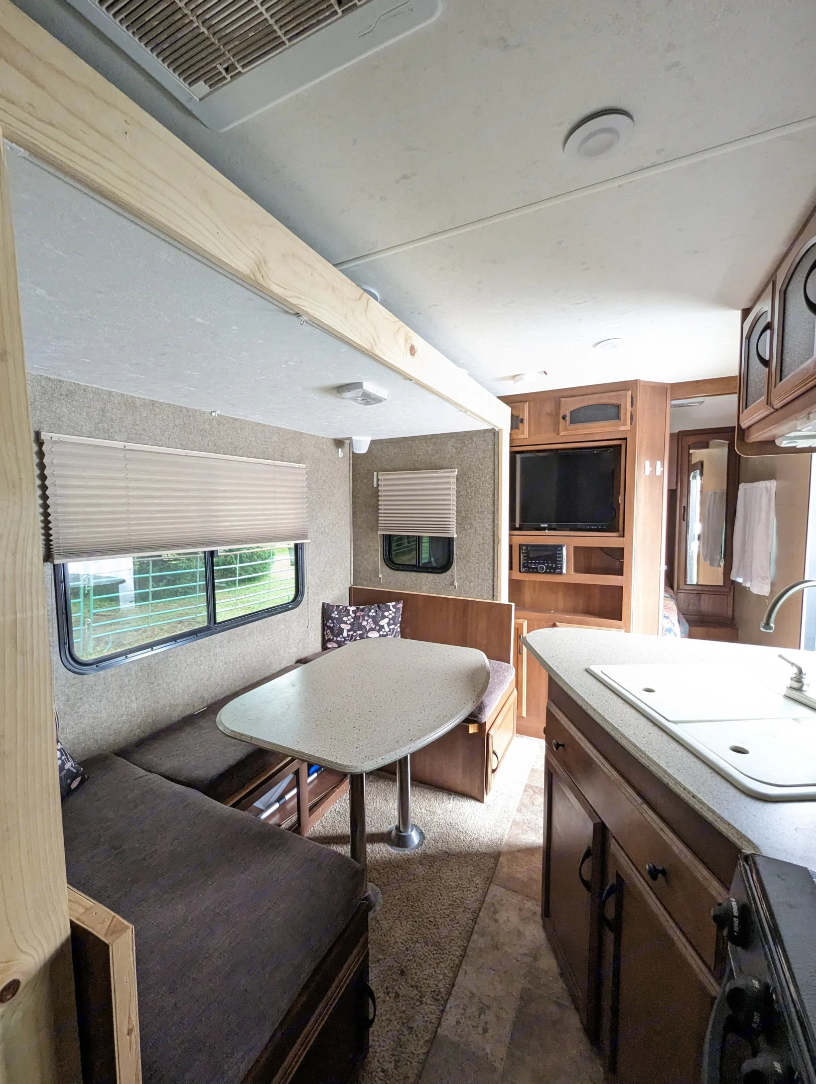 Standing next to the fridge, bunk beds on the same side as dining table. Slide out is in, additional 6' x 10' of floor space when out. Queen bedroom . Coachmen Freedom Express 2015