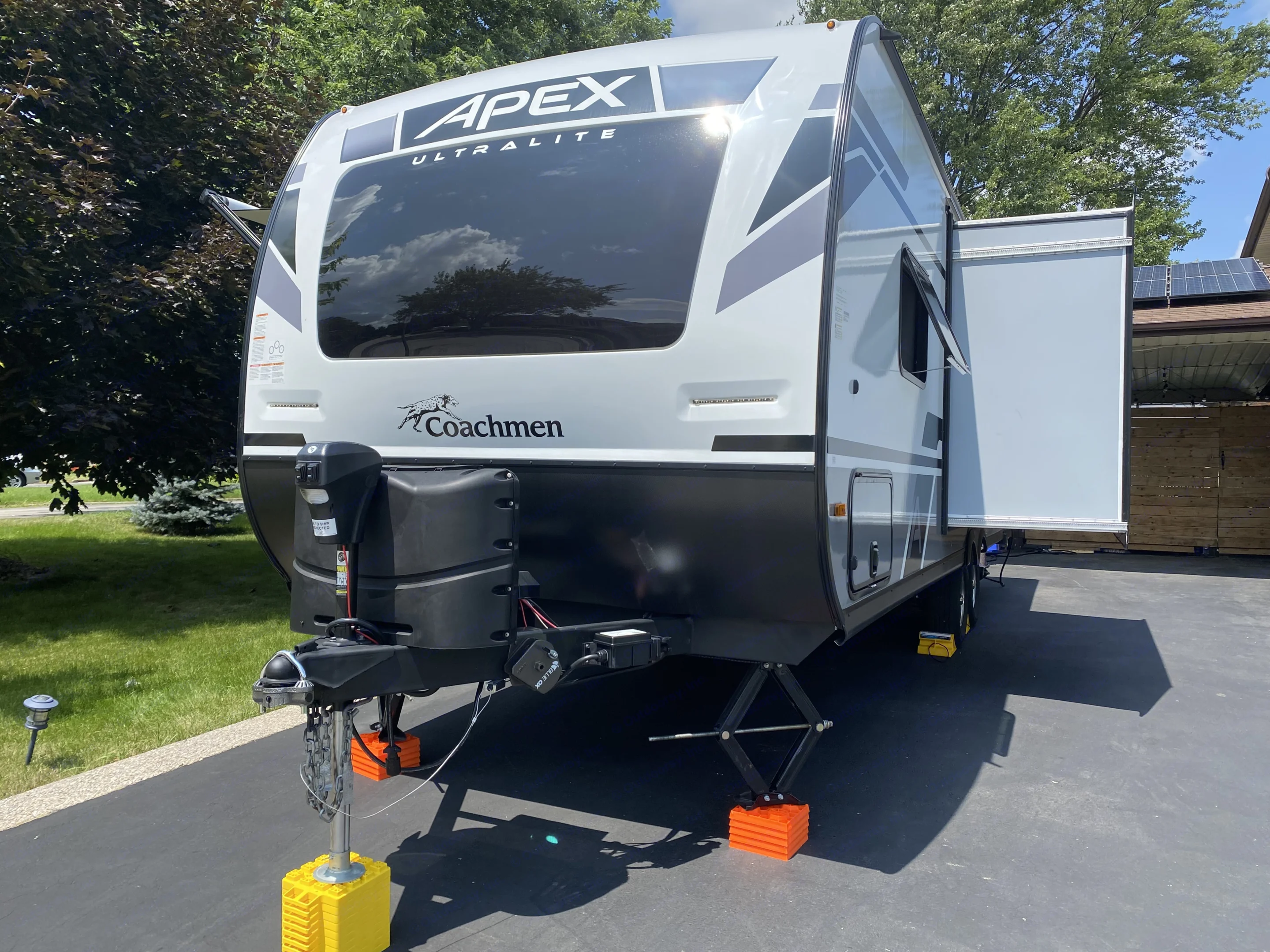 The front of the trailer with slide out, out. Coachmen Apex 2023