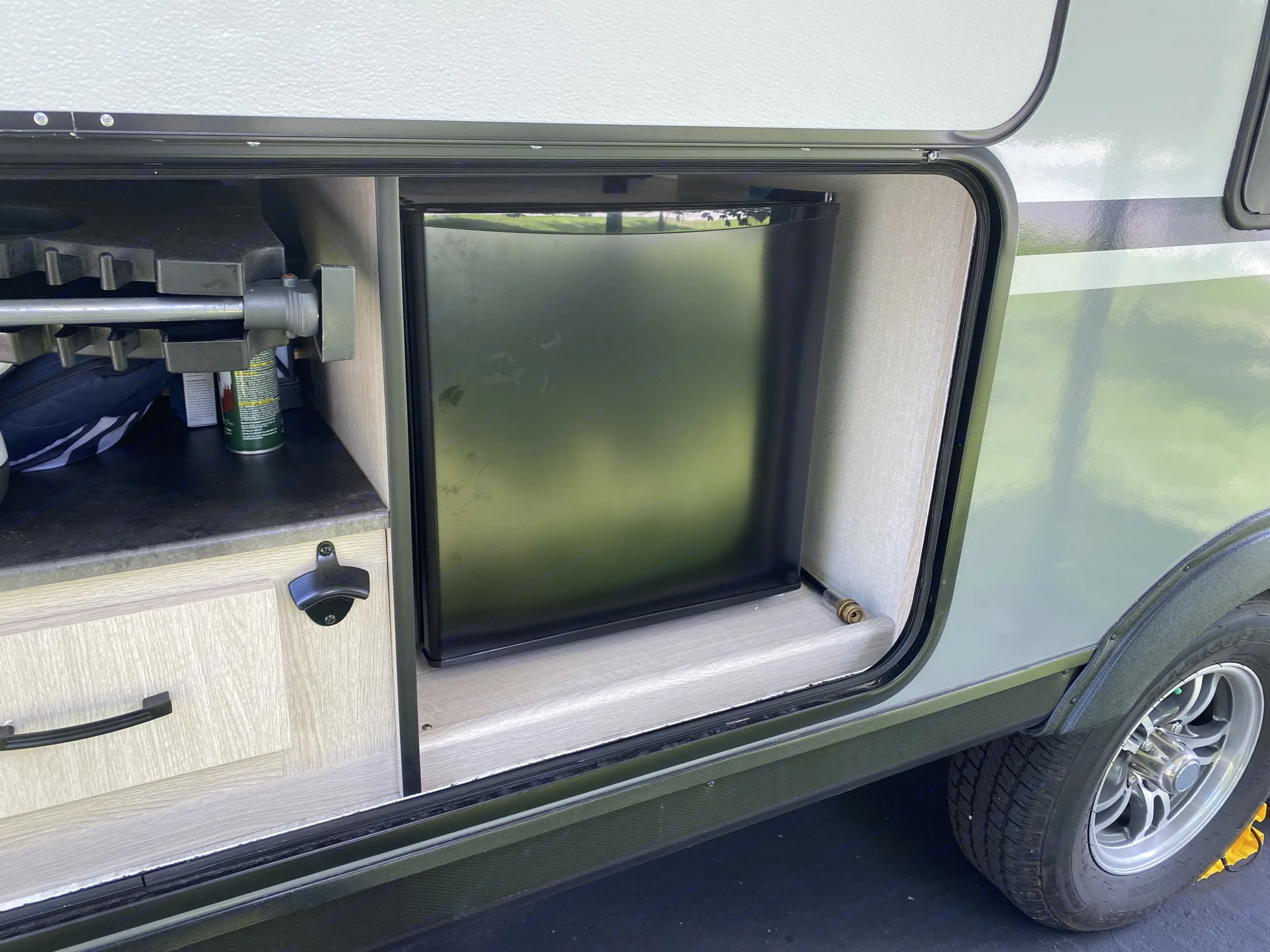 The exterior kitchen, the mini fridge. Coachmen Apex 2023