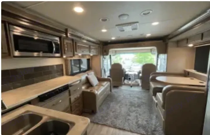 The couch and table with the hide away tv raised. . Jayco Precept 2019