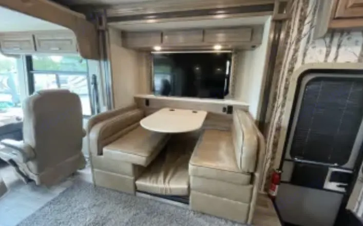 Kitchen table with the hide away tv up. . Jayco Precept 2019