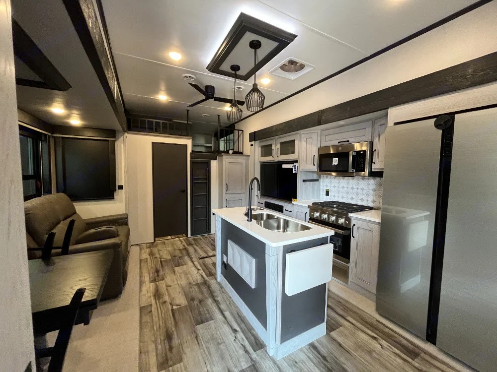 Tour this modern RV rental! Spacious interior with a full kitchen, island, and cozy living area. Perfect for travel.. Keystone RV Montana High Country 2023