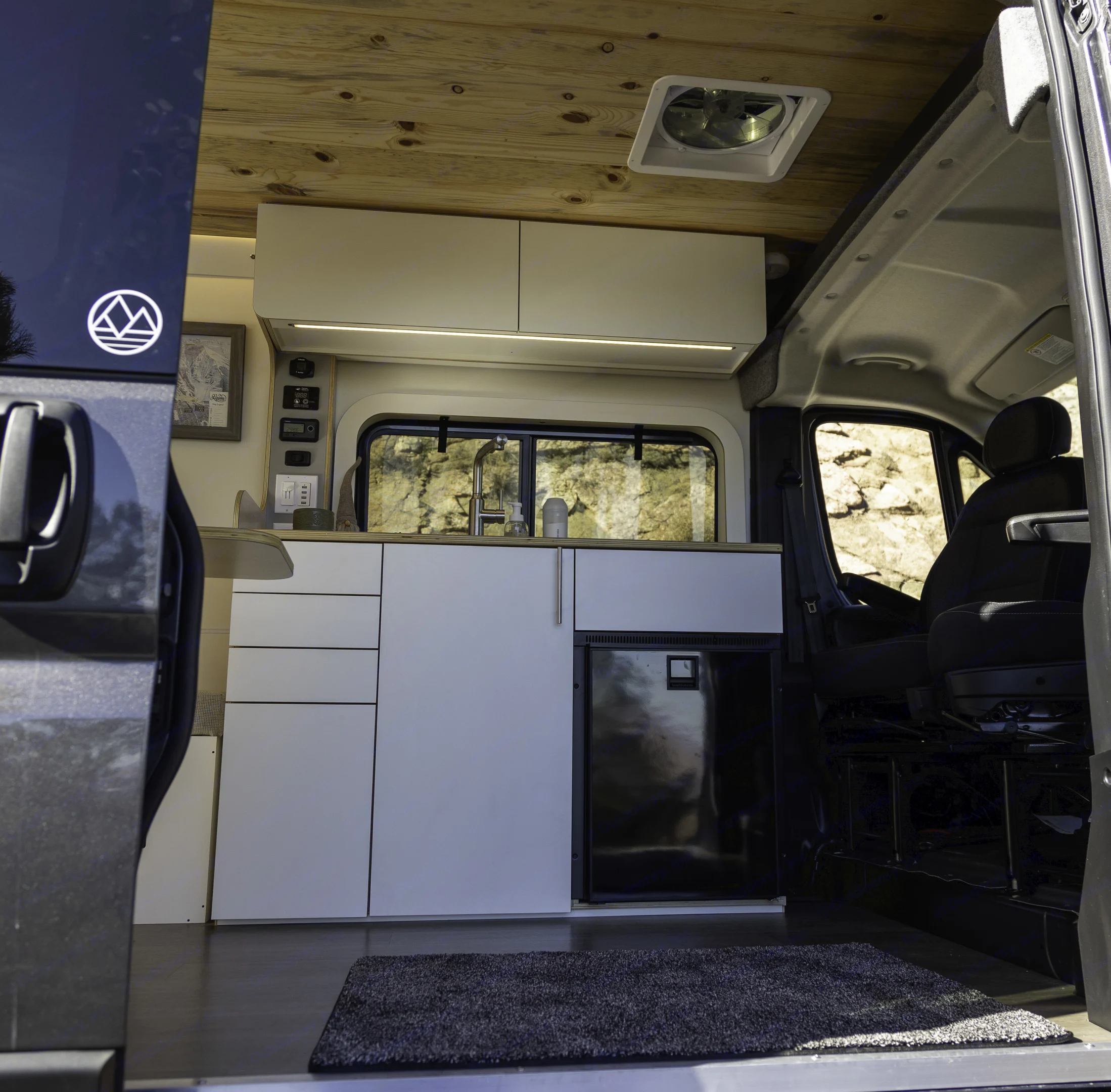 Rocky's kitchenette has an 85L refrigerator, fully-interior plumbing system, induction cooktop, and plenty of storage. Dave & Matt Vans Dave & Matt Vans Class B 2023