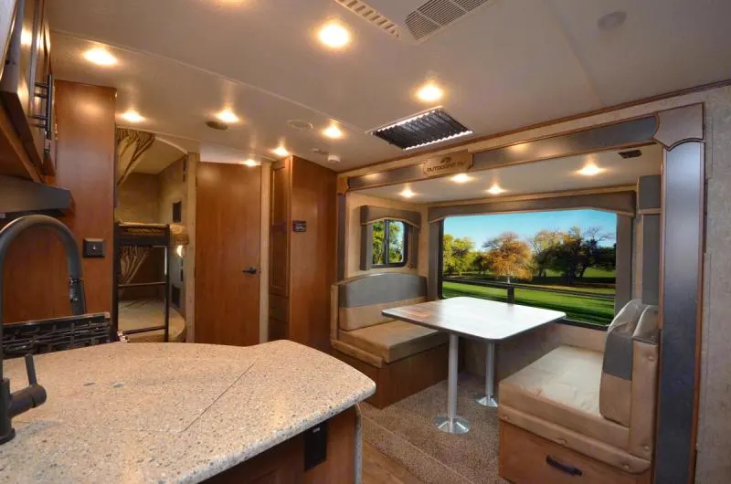 Extra large table slide out with surround windows, and converts to queen bed with under storage. Kitchen with solid tops and vaulted ceiling. . Outdoors RV Timber Ridge 2022