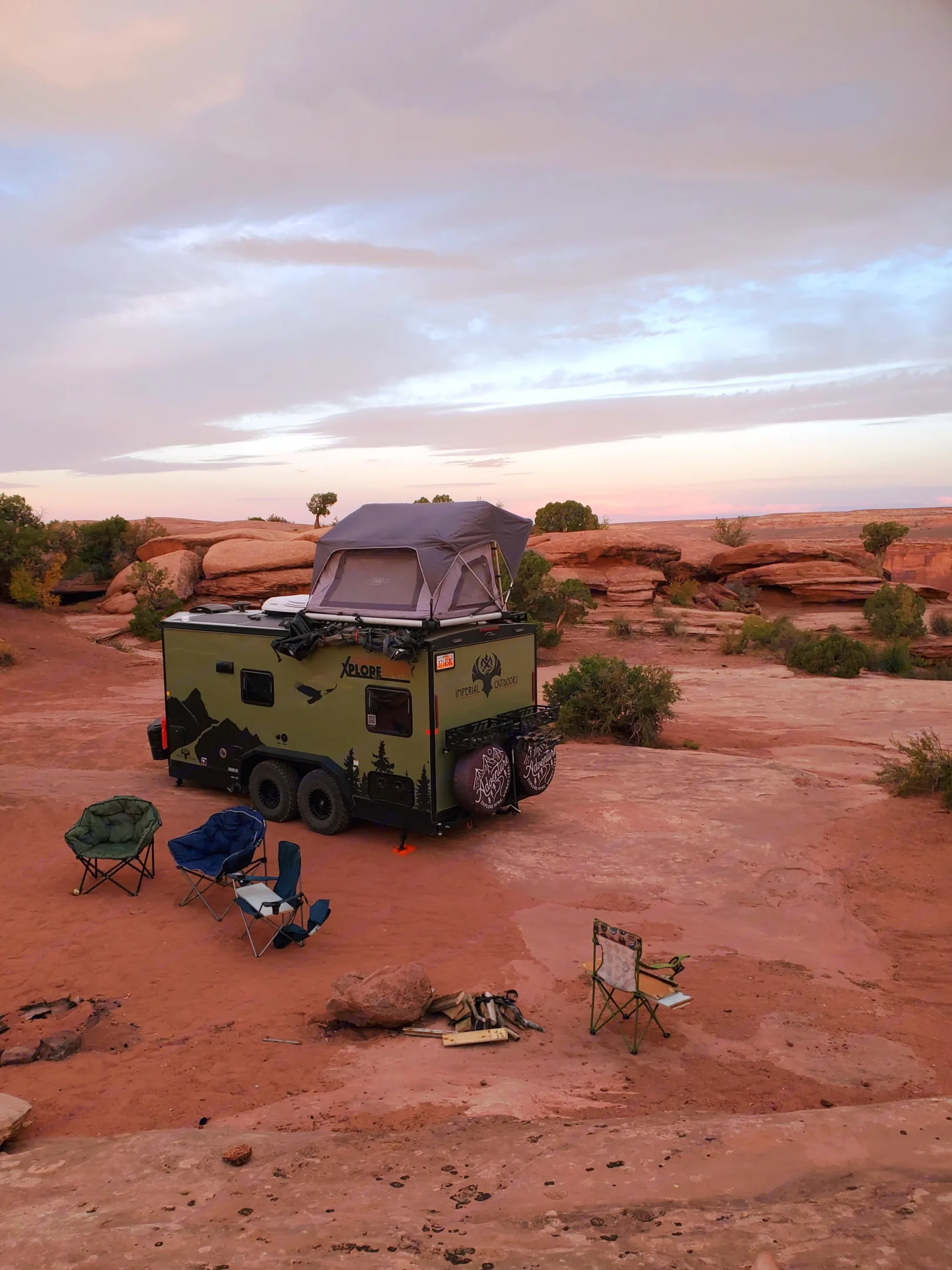 Exterior view of the tent opened with camping chairs.. Imperial Outdoors XploreRV 2023