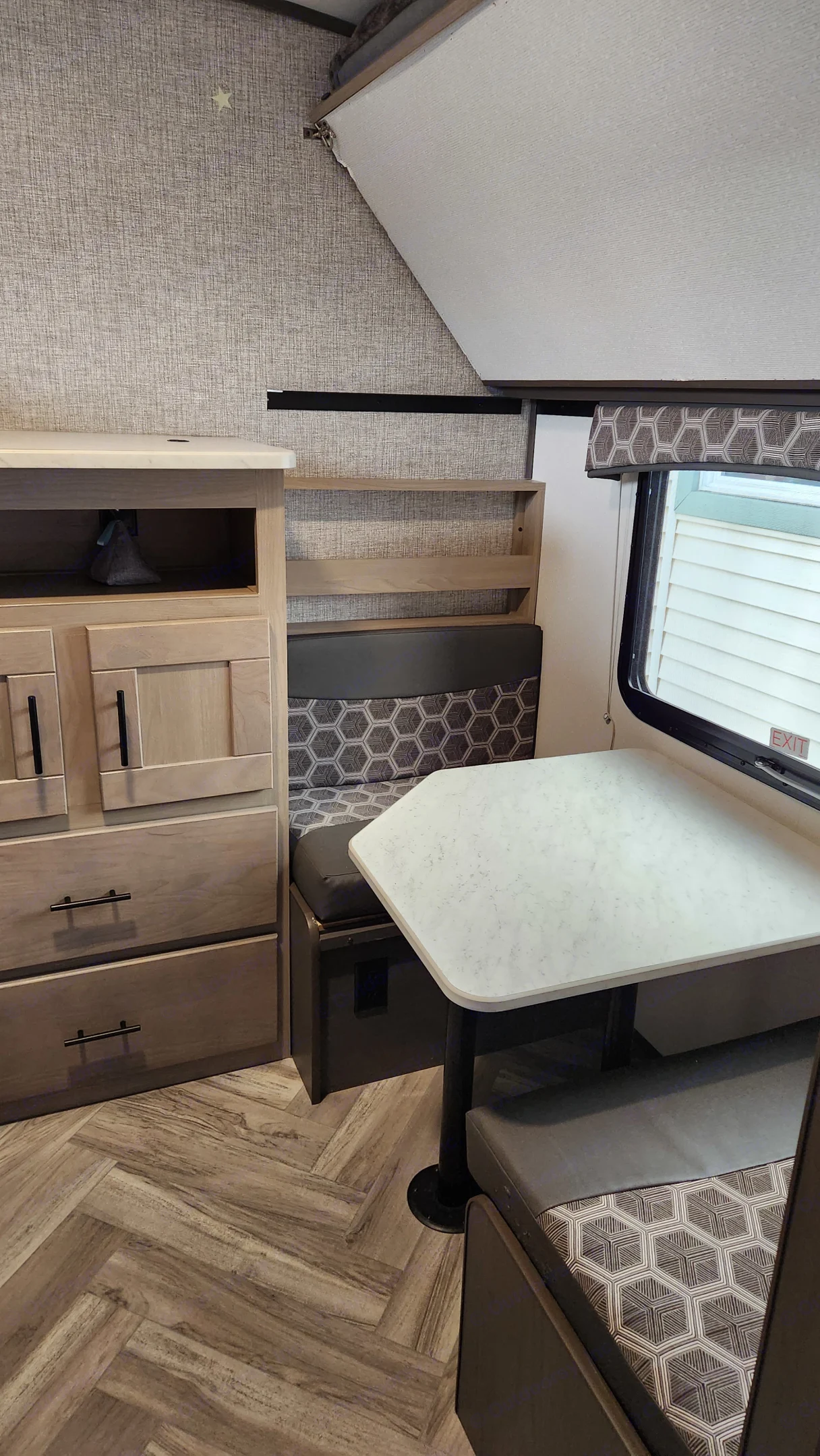 separate table and sitting area for overflow or kids game area. Also folds down to make another bunk . Cruiser RV Shadow Cruiser 2021