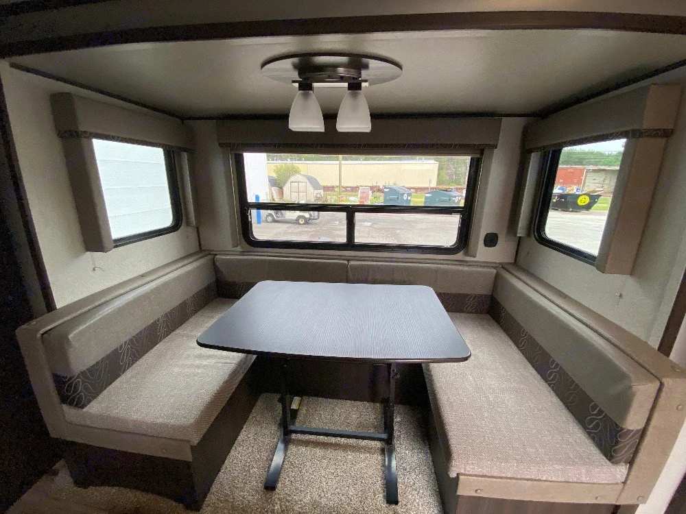 dining table with storage underneath the bench seats, the dining table folds down to make a nice bed. The dining seats have floor lights for evening safety and can be used as night lights too.. Keystone RV Springdale 2018