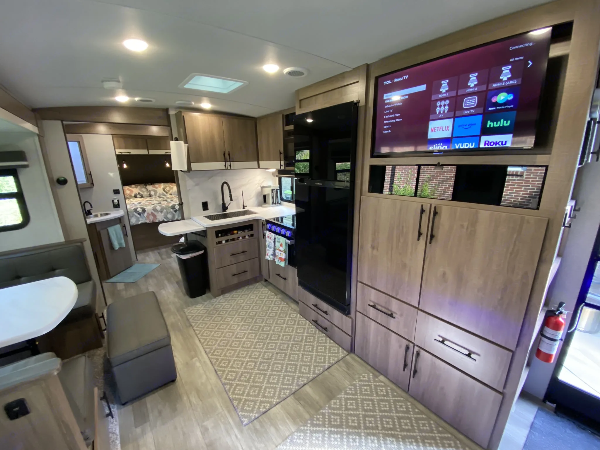 TV is directly in front of the recliners, making them the best spot in the house for some movie entertainment. Lots of storage below the TV offers places for snacks and other items. . Grand Design Imagine 2023