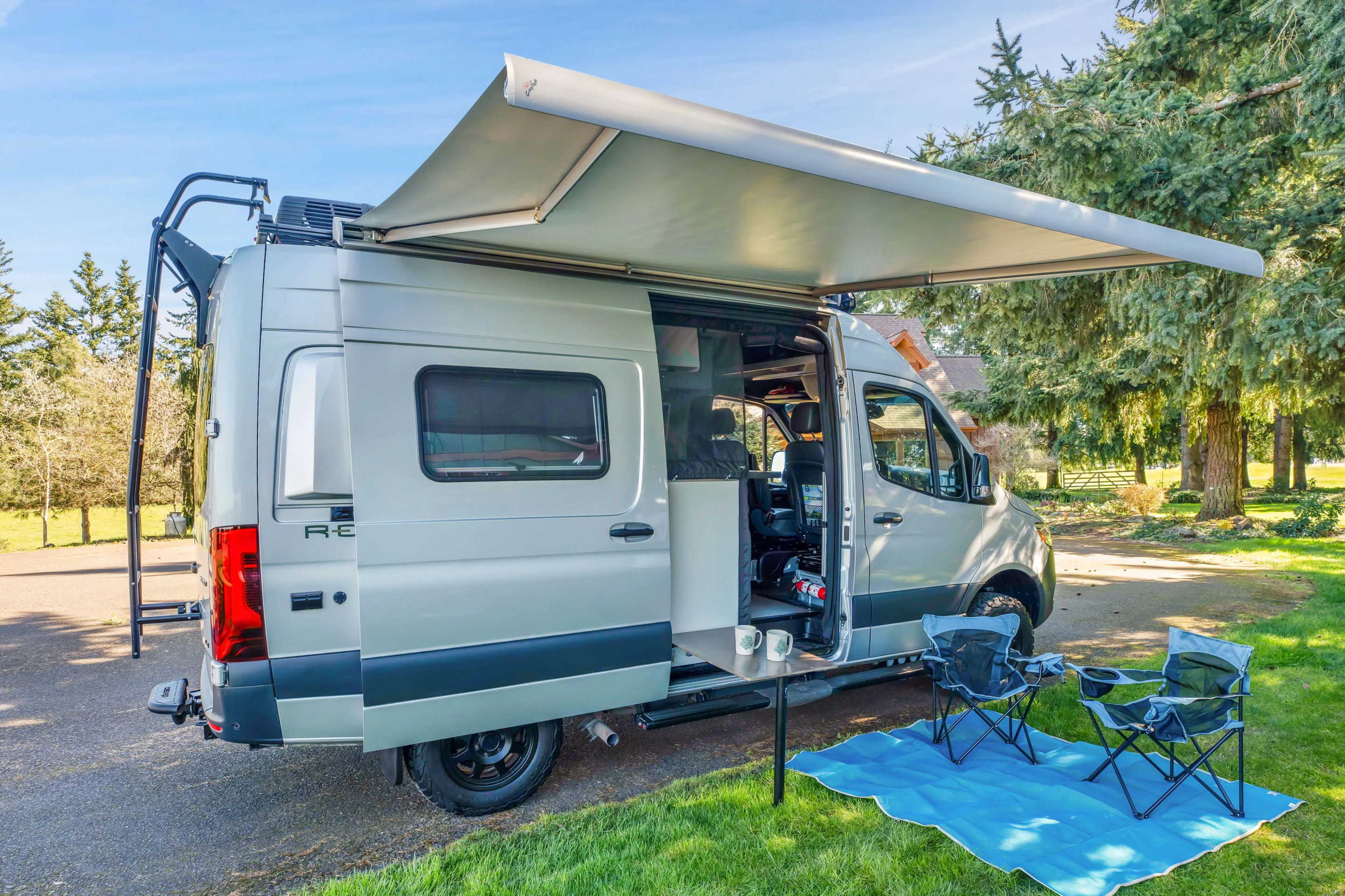 Power retractable awning, self closes in high wind. Van comes with 2 camping chairs and mat. Winnebago Revel 2020