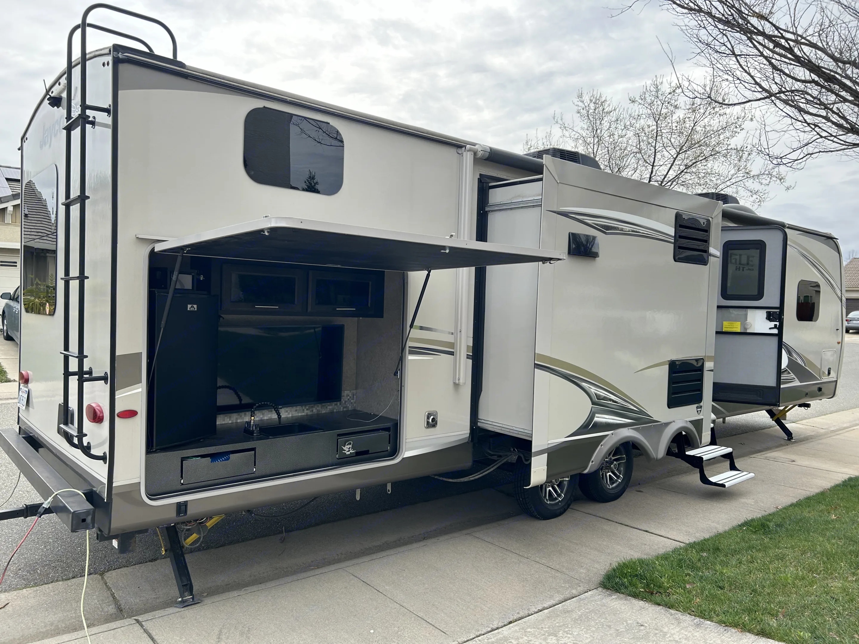 Exterior kitchen, tv, and refrigerator. Jayco Eagle HT 2018