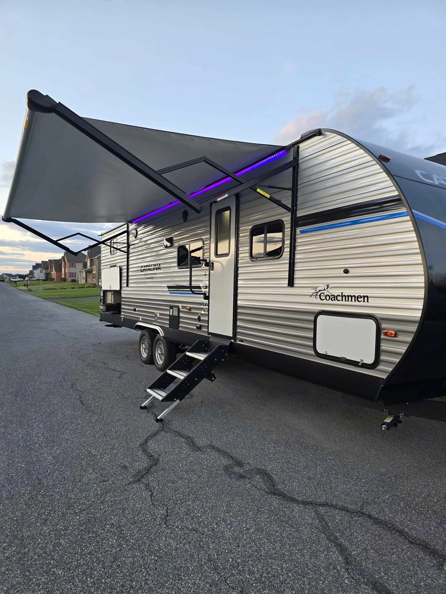 Experience outdoor adventures! This sleek RV rental with a lit awning and steps awaits. Perfect for your next camping trip.. Coachmen Catalina Legacy 293QBCK 2023