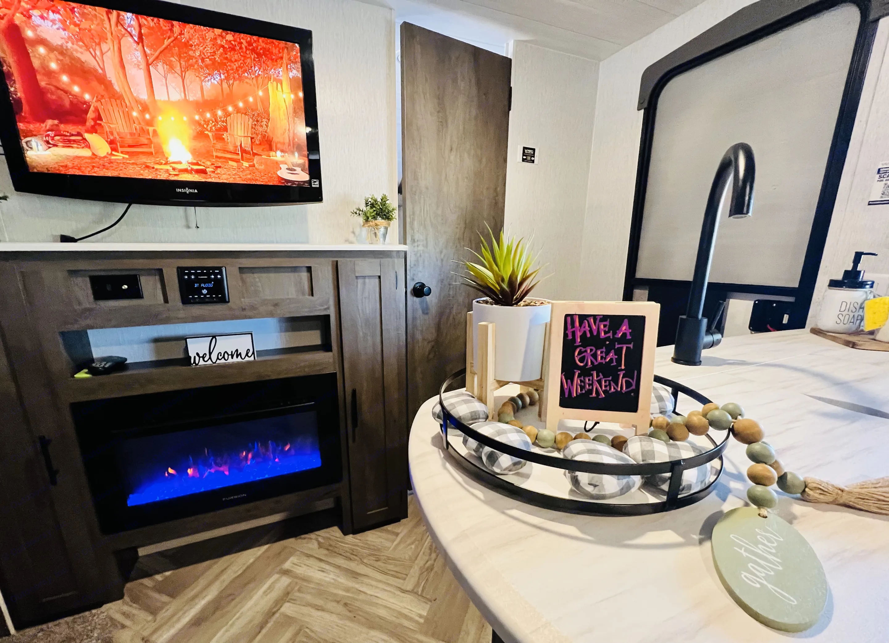 Entertainment:
Stay entertained throughout your stay with a Bluetooth stereo system and speakers both indoors and outdoors.
Enjoy your favorite shows on the 32” wall-mounted TV or indulge in a movie night with the included DVD player.
• Cozy Ambiance: Relax in the warmth and charm of the electric fireplace, offering both comforting heat and colorful ambiance. . Forest River Wildwood X-Lite 2022
