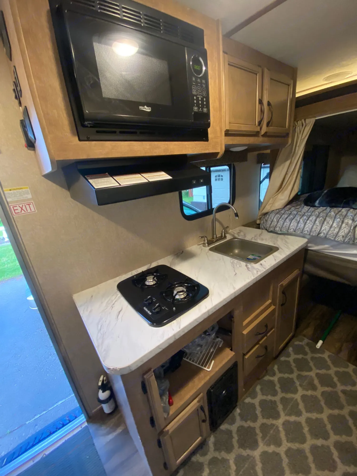 Microwave, stove top range, sink, cabinets with all kitchen cooking supplies you could ever need. . Starcraft Launch Outfitter Extreme 2018
