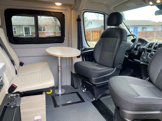 A table that is stored behind the backseats sets up very easily to create an area for all to gather. . Winnebago Solis 2021