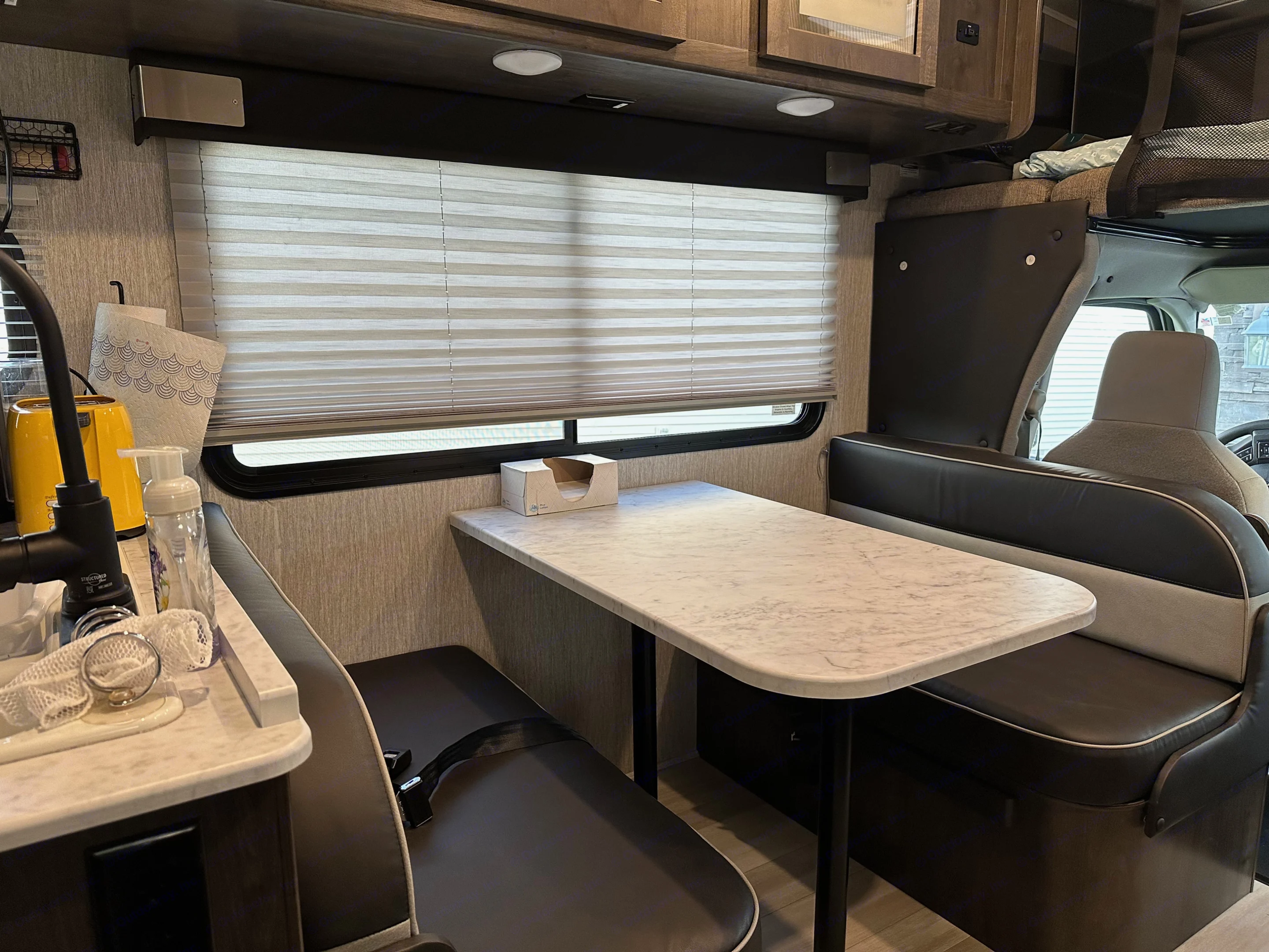 Dining booth has 4 seatbelts for passengers. One of them has anchors for a carseat. This booth also converts into a bed.. Forest River Coachmen Leprechaun 2021