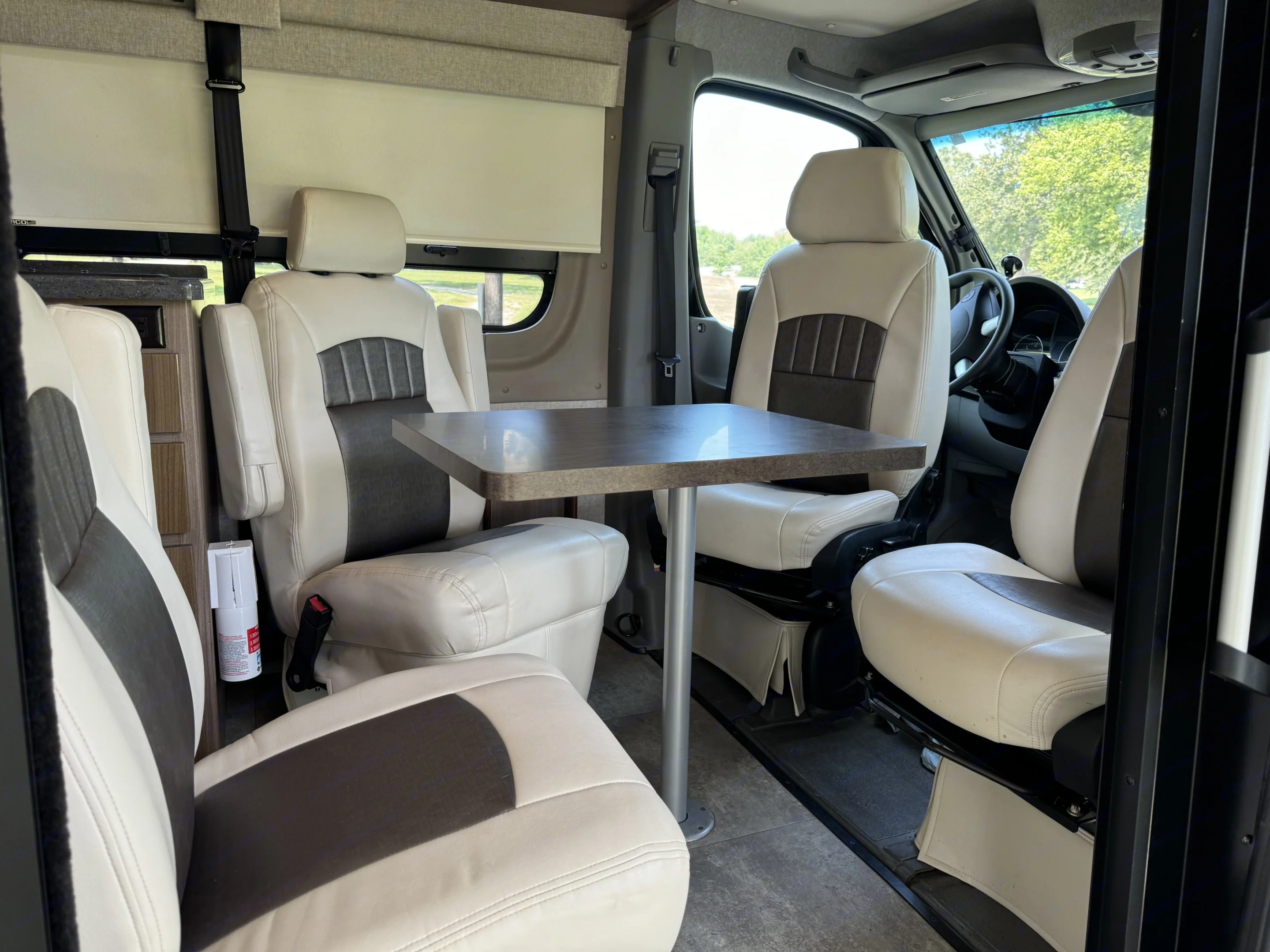 Three of the captains chairs can be swiveled to provide round-the-table seating for four.. Winnebago ERA 170X 2016