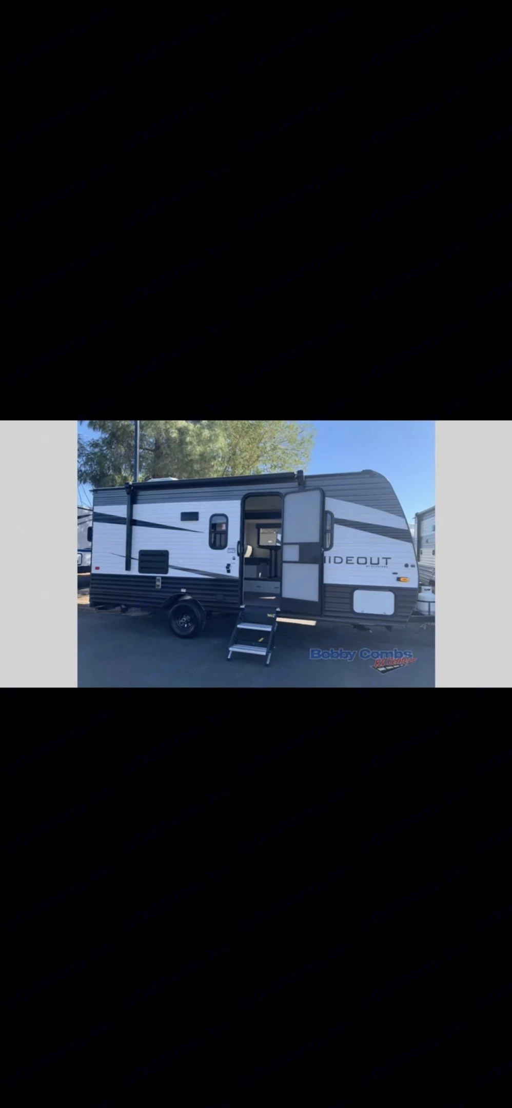 Explore a white & gray Hideout travel trailer RV rental, parked outdoors with steps down from its open door.. Keystone RV Hideout 2021