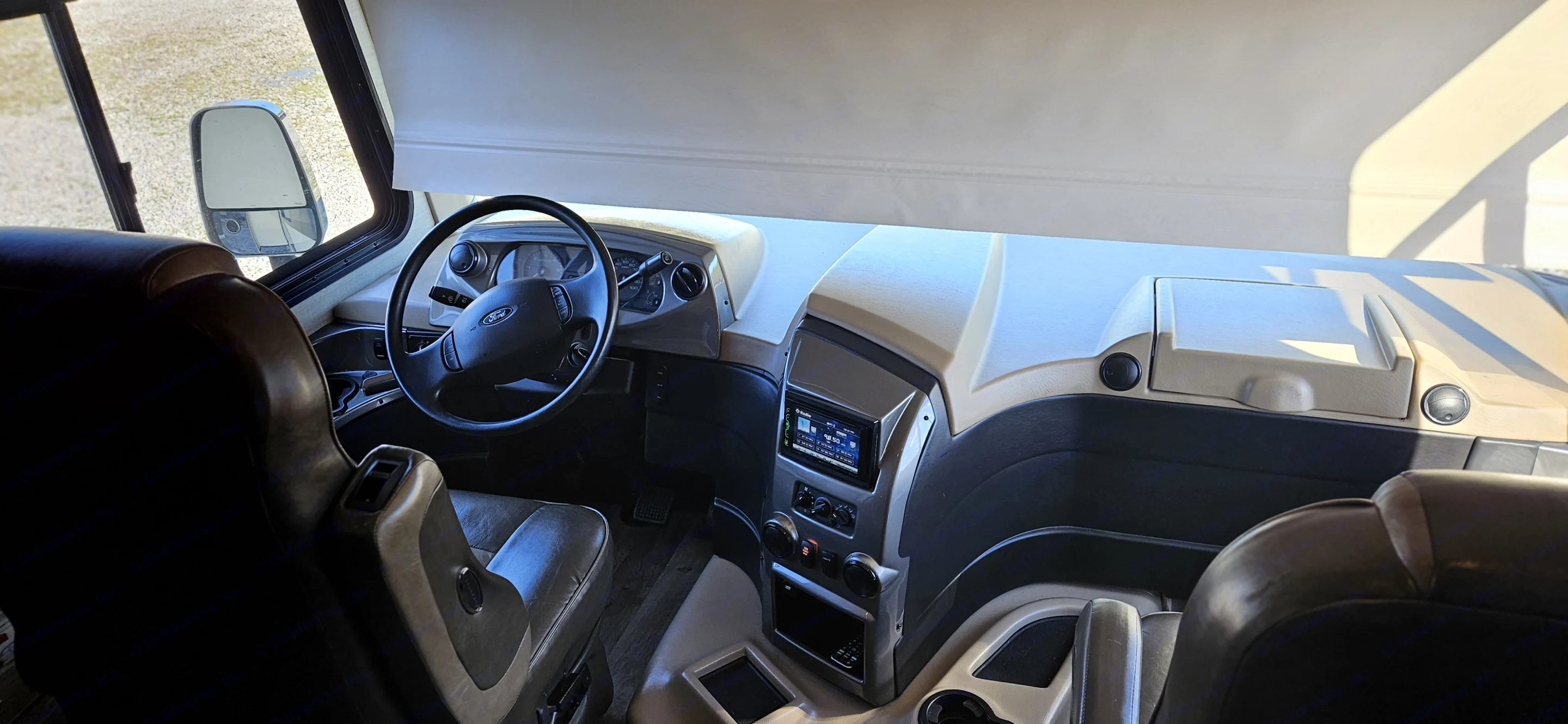Spacious RV rental cockpit view: driver's seat, steering wheel, and dashboard with infotainment system ready for the road.. Jayco Precept 2019