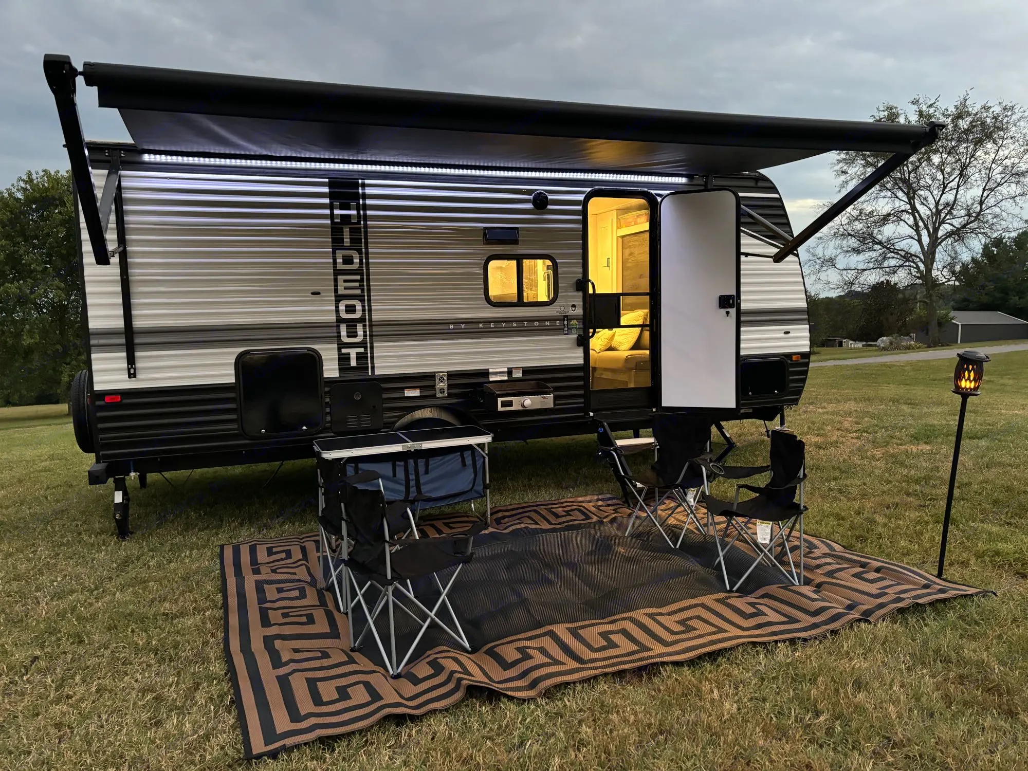 Enjoy the large canopy and camping furniture included!. Keystone RV Hideout 2023