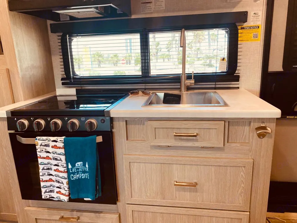 Our camper has a sink, a stove range with three gas burners, exhaust fan and two drawers for store in the bottom and in the top good size pantry storage as well. . Forest River Flagstaff E-Pro 2022