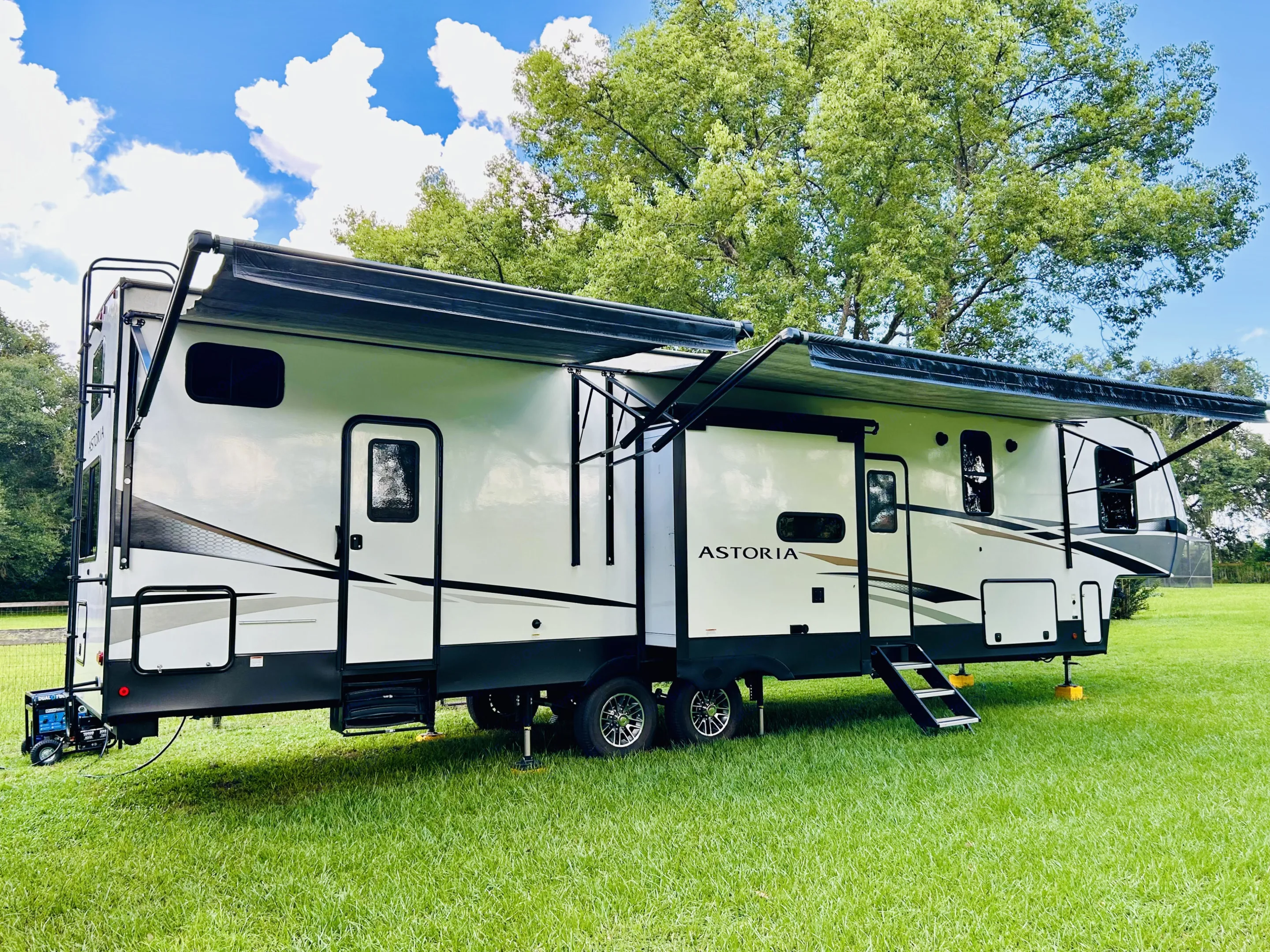 Two entry/exit doors w/ screens on each door, 2 awnings, 3 slides (2 on opposite side); small compartment holds outside beverage fridge and metal rails are for attaching the outdoor griddle. Dutchmen 3603LFP 2022