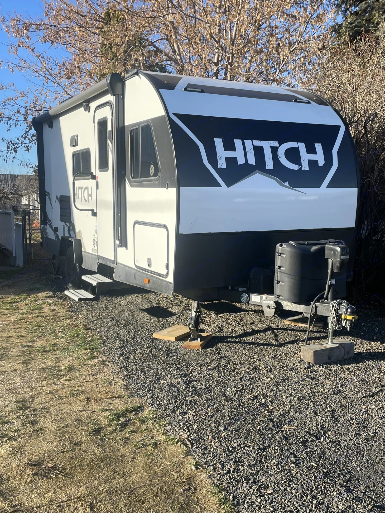 White HITCH RV travel trailer parked on gravel, showcasing a potential rv rental setup for outdoor adventures.. Cruiser RV Hitch 2022