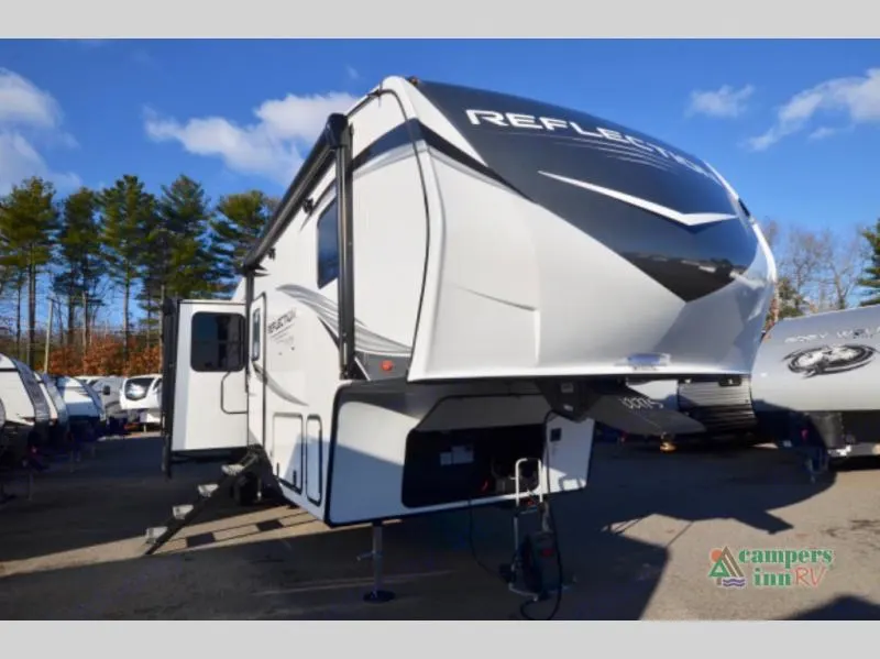A modern white fifth-wheel RV is parked outdoors with steps down, ready for entry. Ideal for your next rv rental.. Grand Design Reflection 2023