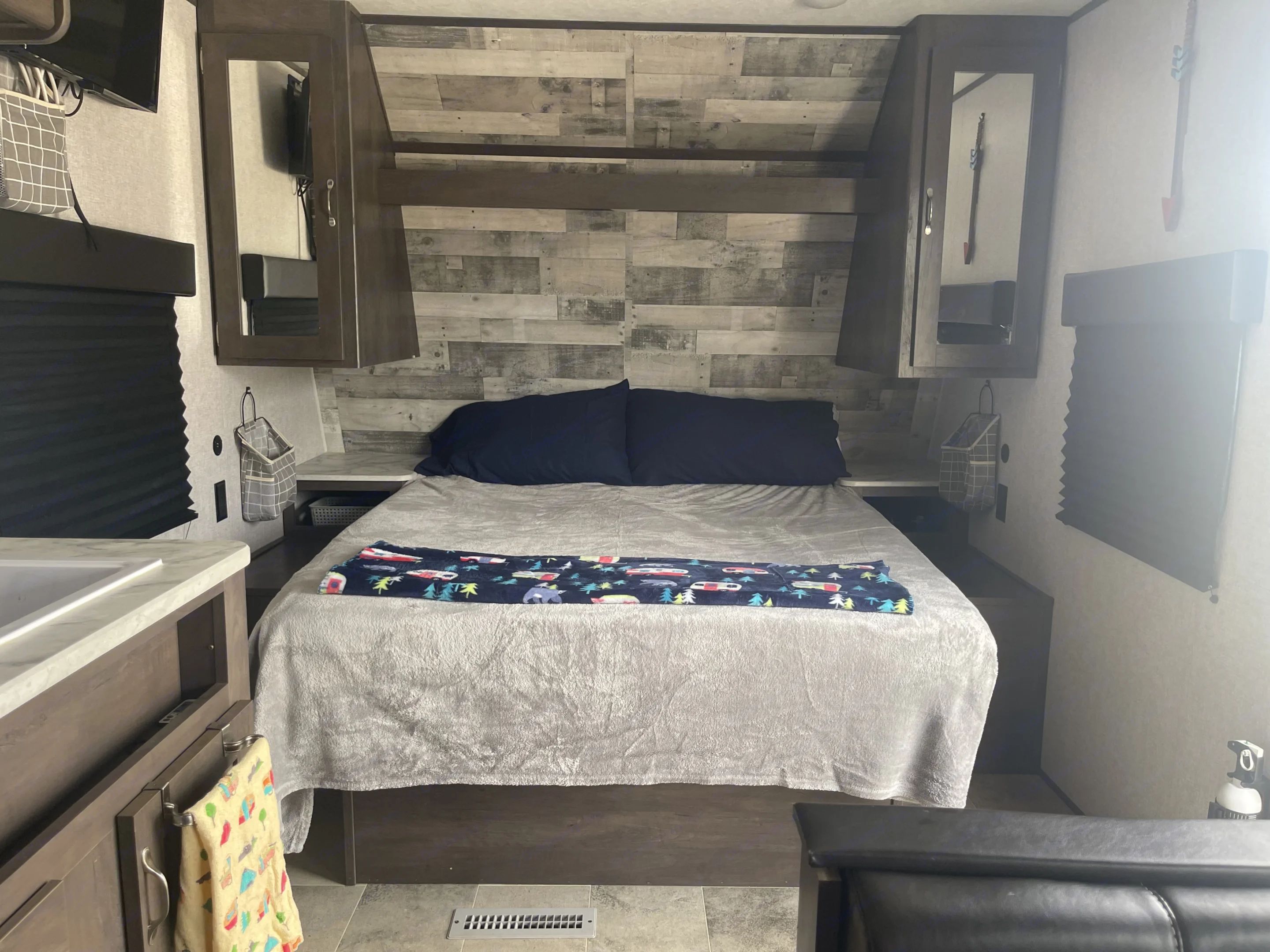 Queen bed with under bed storage, 2 closets, 2 nightstands, 2 USB charging stations at each bedside . Dutchmen Coleman Lantern LT 2021