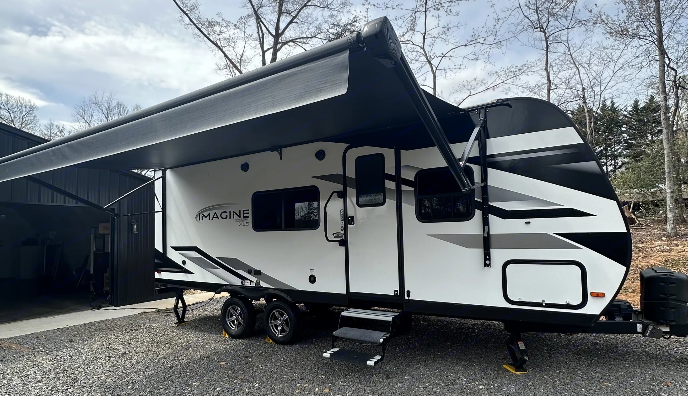 This sleek white and black travel trailer, branded 'IMAGINE XLS', is an ideal RV rental. Its extended awning offers shade for. Grand Design Imagine XLS 2022