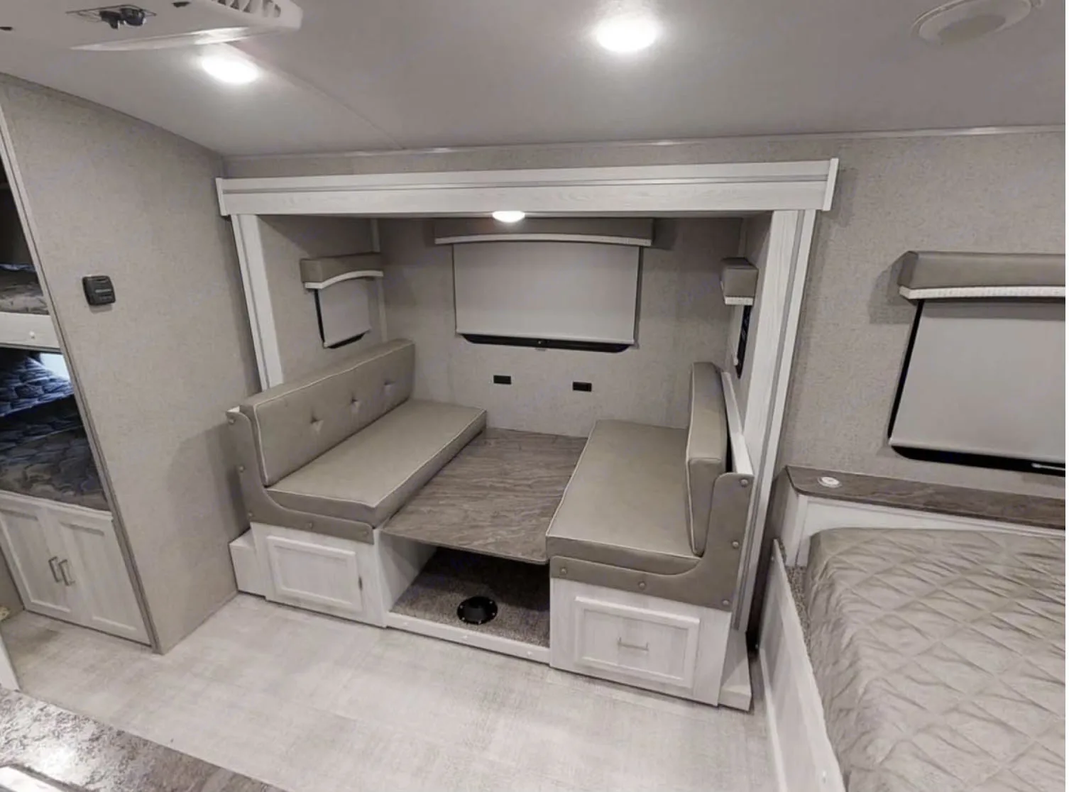 Cozy RV rental interior featuring a convertible dinette, bunk beds, and a comfortable master bed for your travels.. Forest River Rockwood Geo Pro 2022
