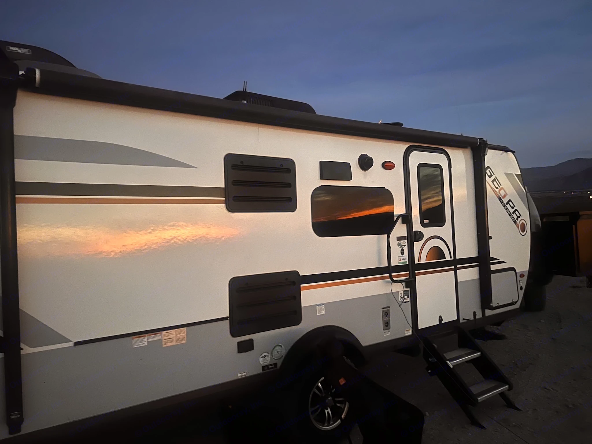 Experience outdoor adventures with this Geo Pro travel trailer, perfect for your next rv rental. Reflects a beautiful sunset.. Forest River Rockwood Geo Pro 2022