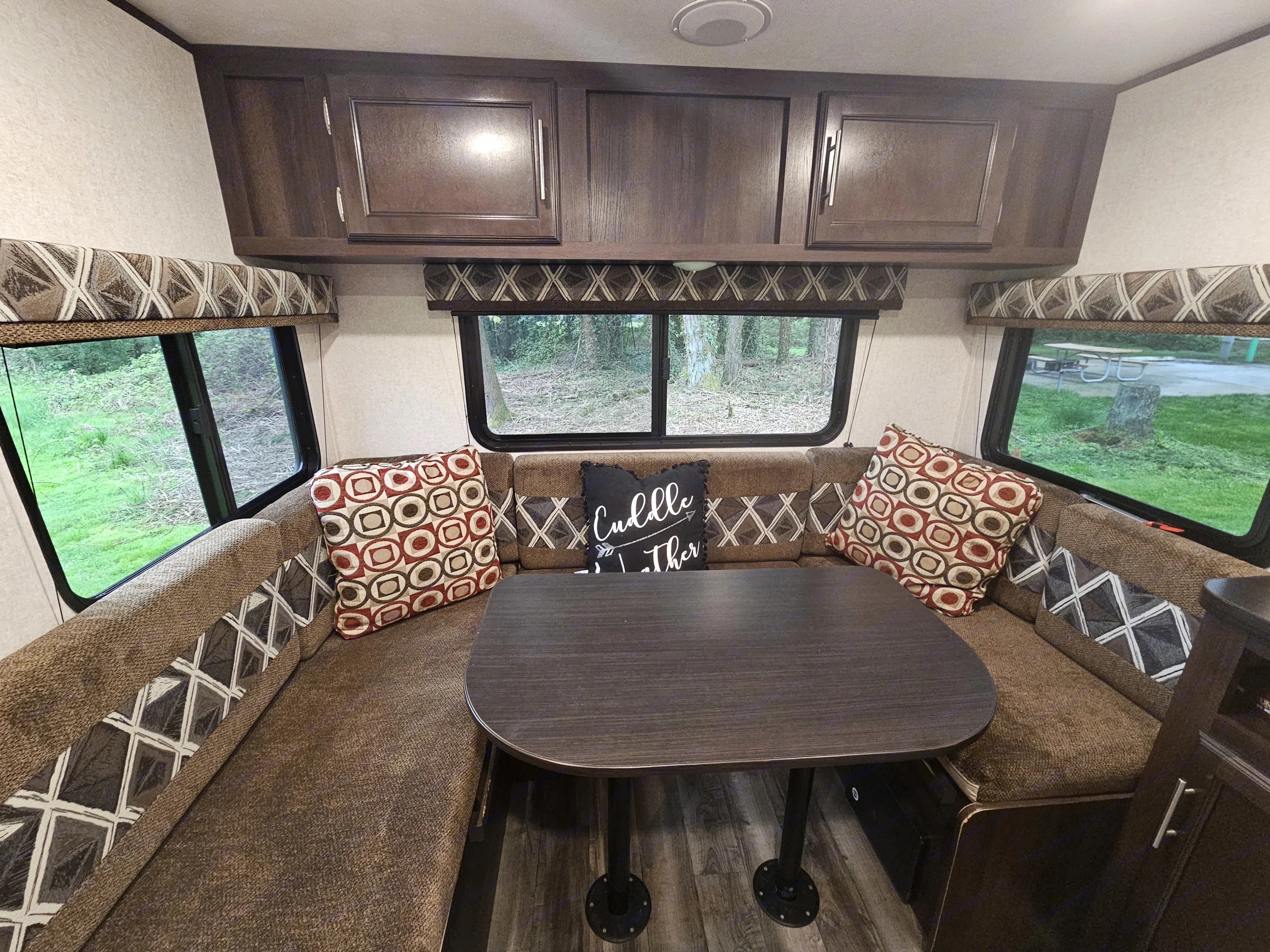 Three large windows providing plenty of incoming light and views. Comfortable U-dinette with vent above. Perfect space for reading or playing games.
Storage cabinets with easy access. Table converts into a bed.. Jayco Jay Flight 2019