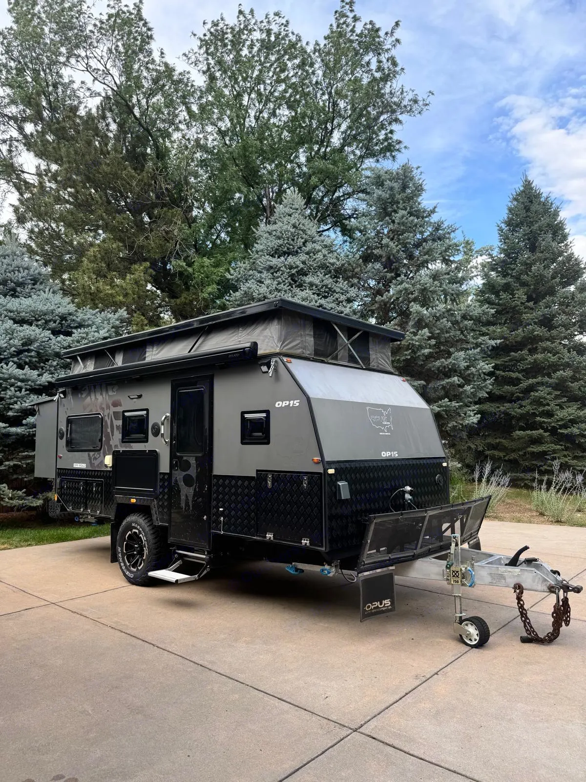 Rugged gray Opus OP15 off-road pop-top travel trailer with diamond plate accents, ideal for rv rental.. Opus OP15 2020
