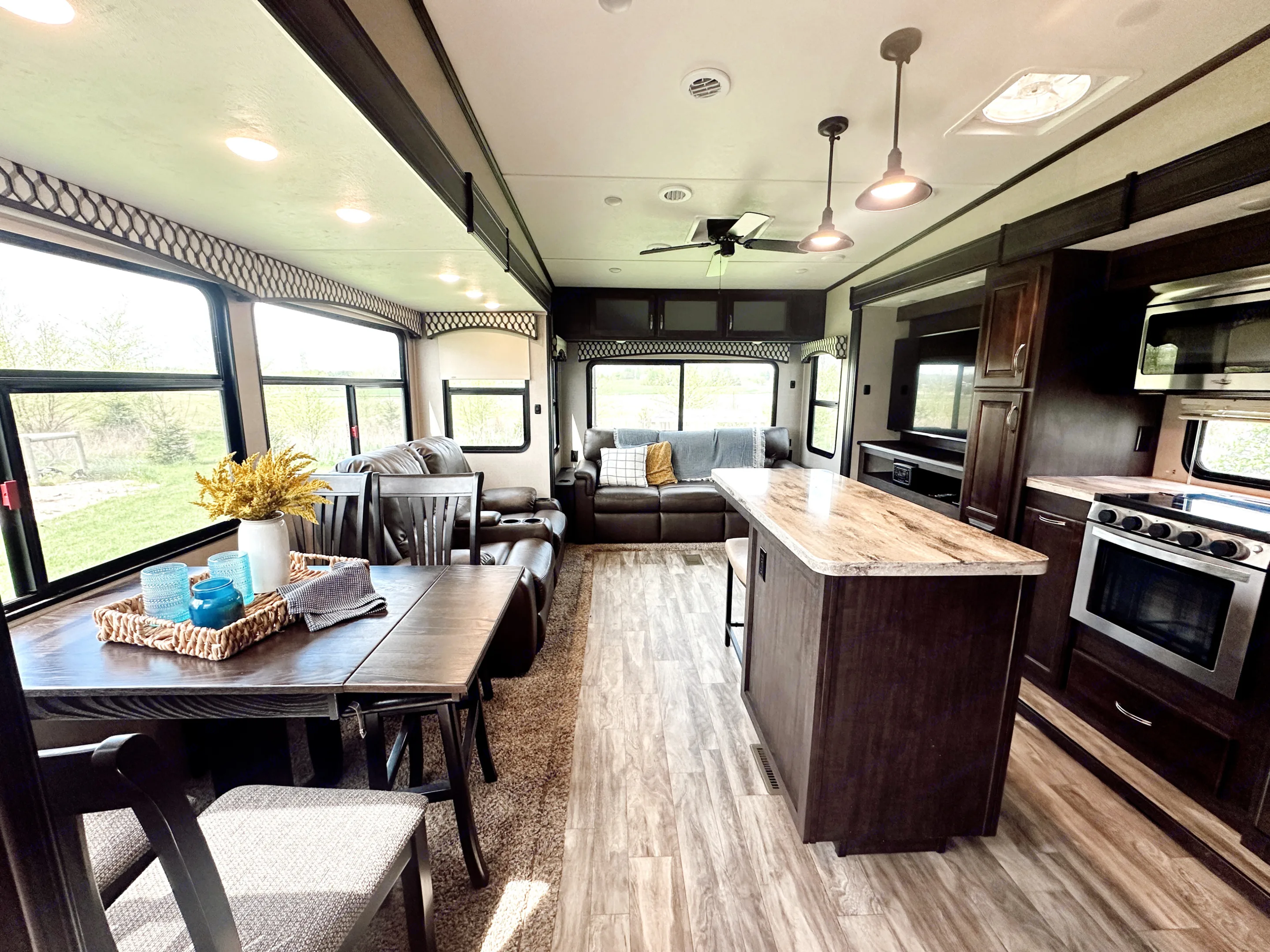 Large living area includes a table & four chairs, reclining theatre seats with heat & massage, and a comfy couch that converts into a queen sized bed.. Forest River Shasta Phoenix 2020