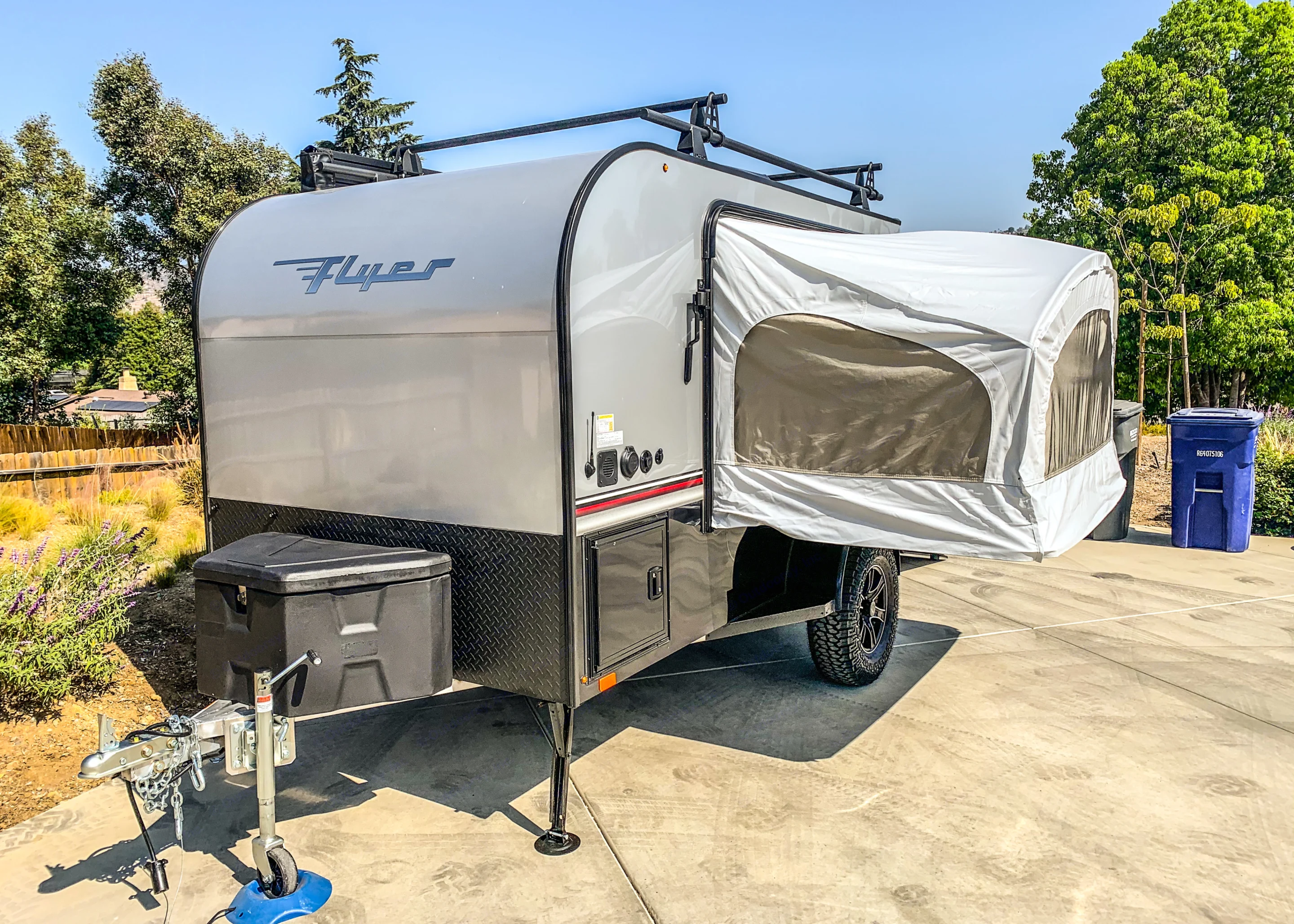 Compact Flyer travel trailer for RV rental, featuring pop-out tent & roof rack. Ready for your next. Intech Explorer 2021